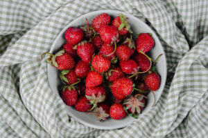 top view fresh ripe strawberries bowl plaid fabric